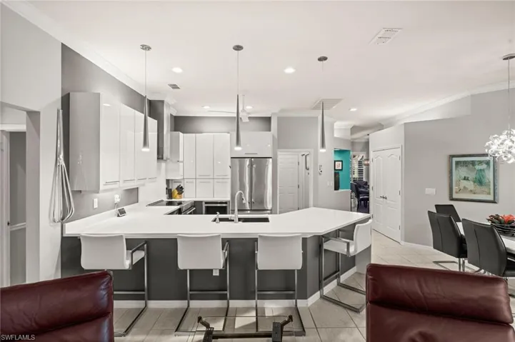Kitchen with ornamental molding, light quartz countertops