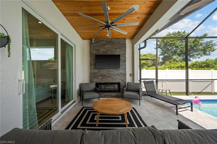 OUTDOOR LIVING ROOM WITH FIREPLACE AND TV