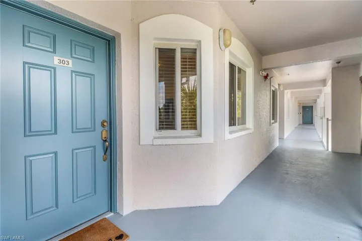 Property entrance featuring stucco siding