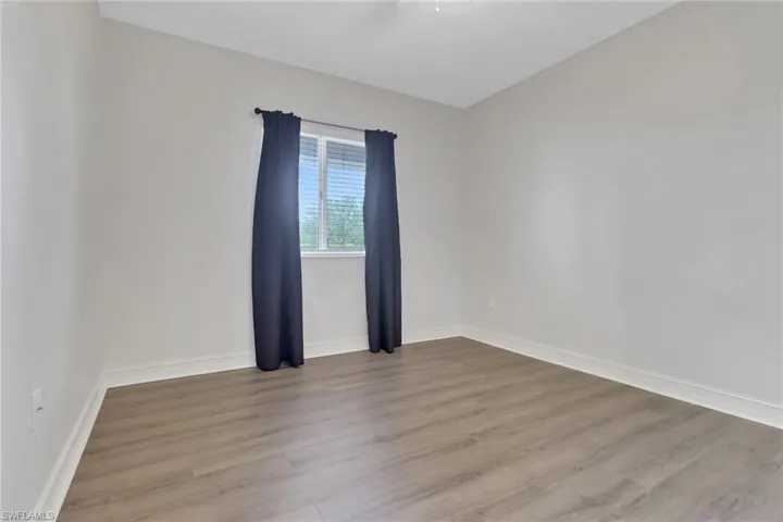 Spare room with wood finished floors and baseboards