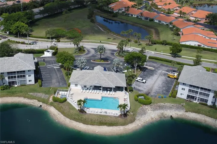 Aerial overview of property's location with a large body of water and a pool