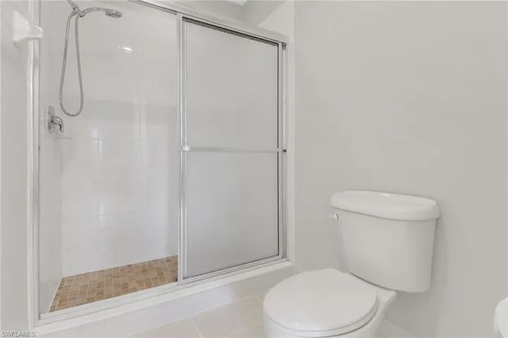 Bathroom with a stall shower and toilet