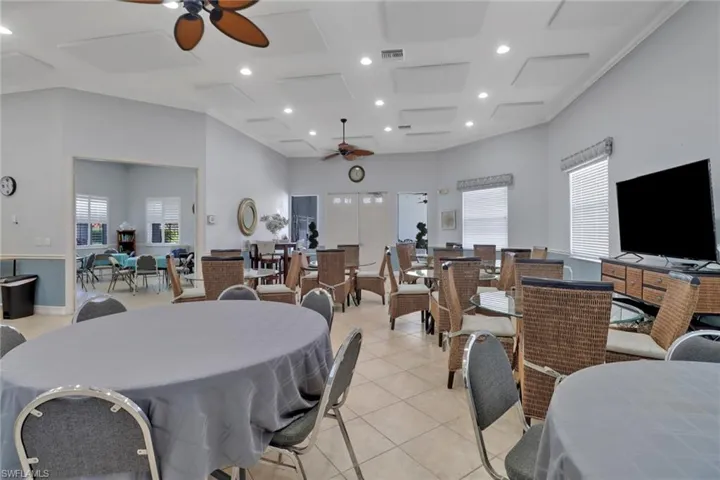 Dining room featuring a ceiling fan, coffered ceiling, recessed lighting, healthy amount of natural light, and light tile patterned floors
