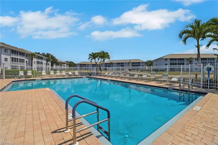 Community pool featuring a patio and a residential view