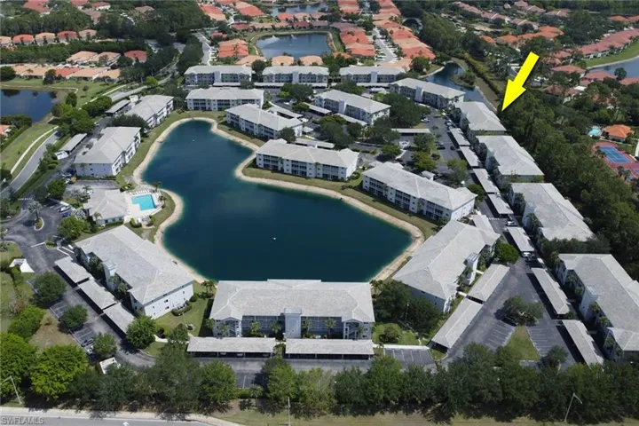 Aerial overview of property's location featuring a nearby body of water and nearby suburban area