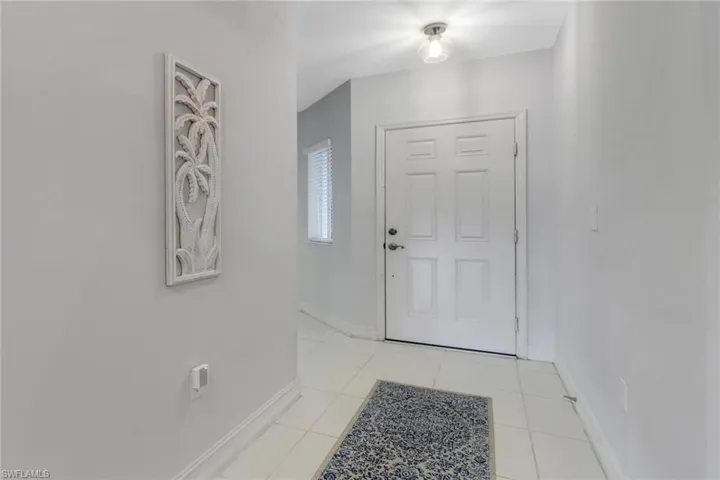 Entrance foyer featuring baseboards and light tile patterned floors