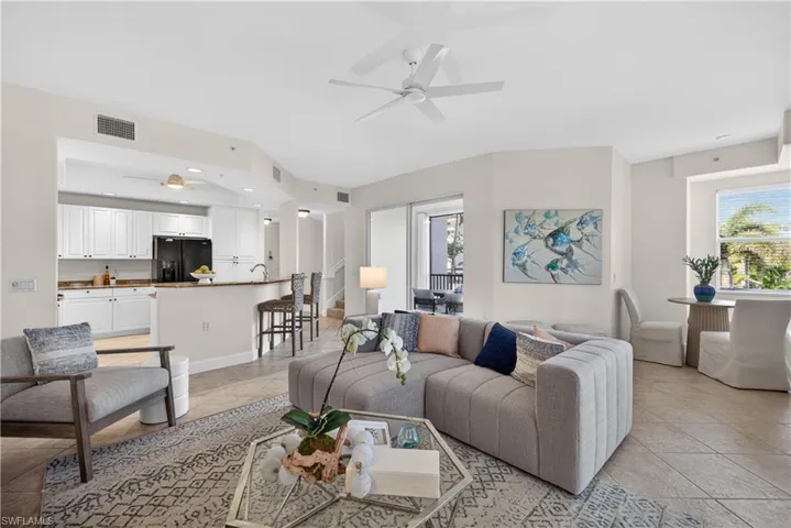 Living area featuring a ceiling fan and light tile patterned floors