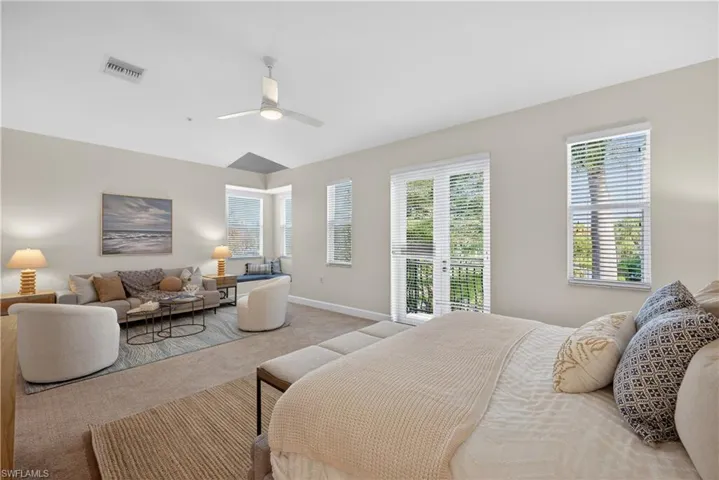 Bedroom featuring carpet, ceiling fan, and access to exterior