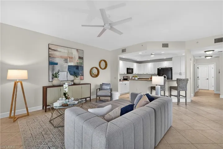 Living room featuring light tile patterned floors, a ceiling fan, and recessed lighting