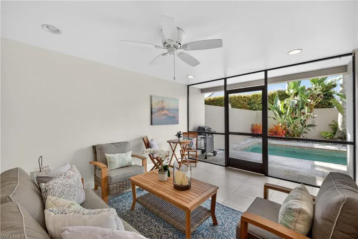 Tiled living room featuring floor to ceiling windows, a ceiling fan, and recessed lighting