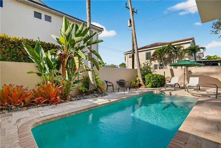 View of pool with patio surround and a fenced backyard