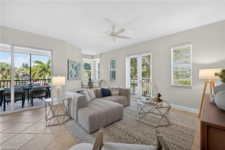 Living room with ceiling fan and light tile patterned floors
