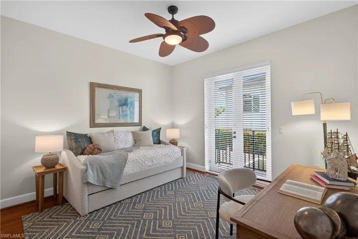 Bedroom with wood finished floors, access to outside, a ceiling fan, and an office area