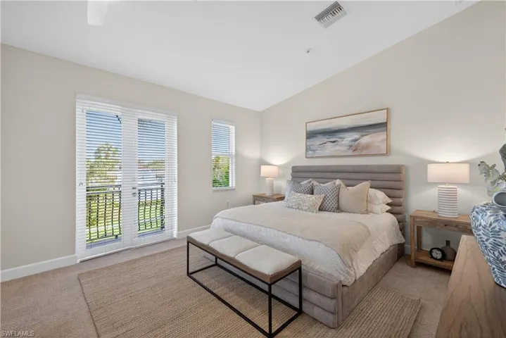 Bedroom with carpet floors, lofted ceiling, and a ceiling fan