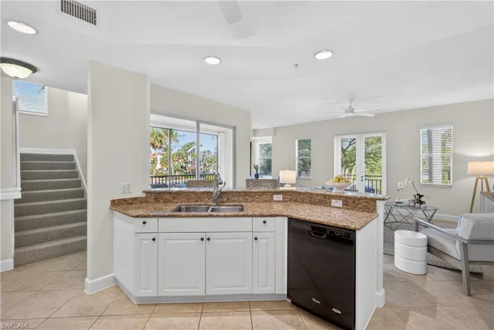 Kitchen featuring white cabinetry, a ceiling fan, black dishwasher, dark stone counters, and recessed lighting