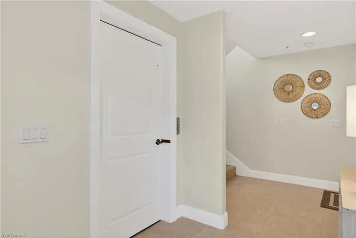 Corridor featuring recessed lighting and light tile patterned floors