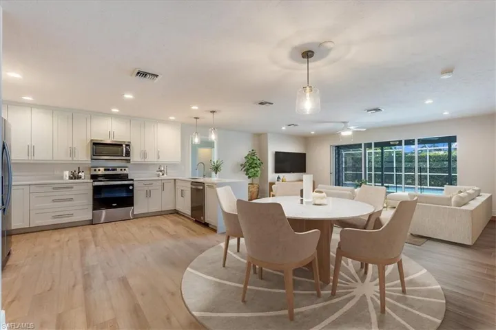 Kitchen Dining Area Adjacent to Open Family Room. Virtually Staged