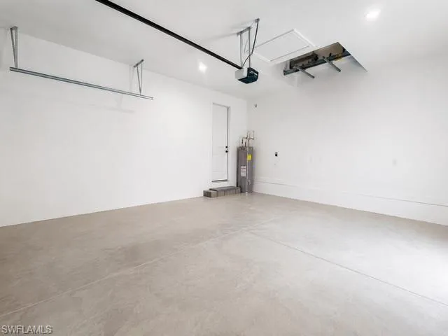 Garage Angle 2- Clean, spacious garage with room for vehicles, tools, and recreational equipment.