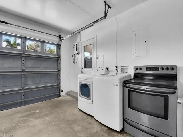 Washroom featuring independent washer and dryer and electric panel