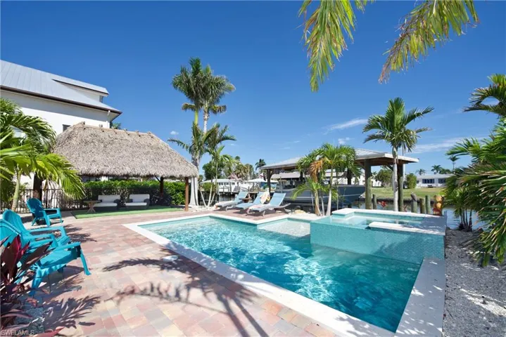 View of pool with an outdoor living space, a water view, a gazebo, an in ground hot tub, and a patio area
