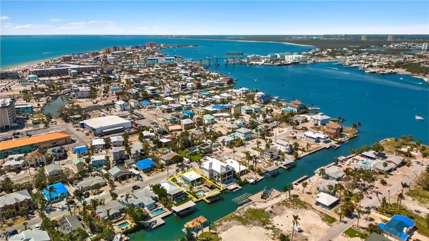 Birds eye view of property with a water view