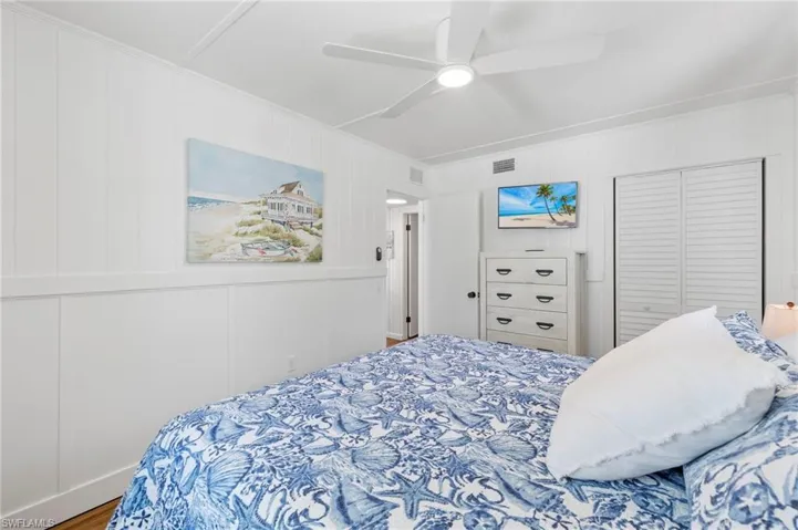 Bedroom with ceiling fan and crown molding