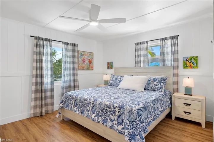 Bedroom with ceiling fan and wood-type flooring