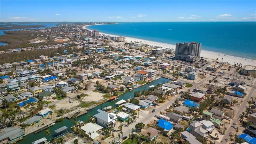 Drone / aerial view with a view of the beach and a water view