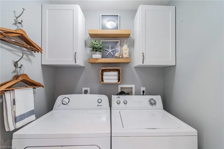 Laundry room featuring cabinet space and washing machine and clothes dryer