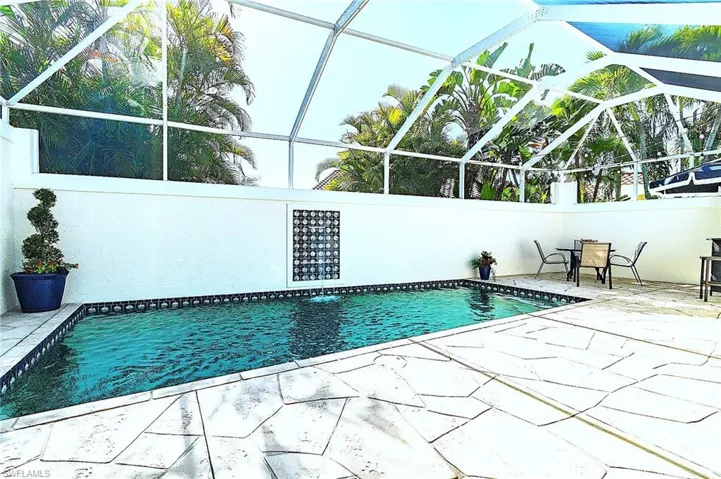 Swimming pool featuring a lanai and a patio