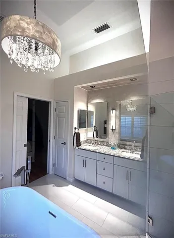 Bathroom featuring double vanity and a soaking tub