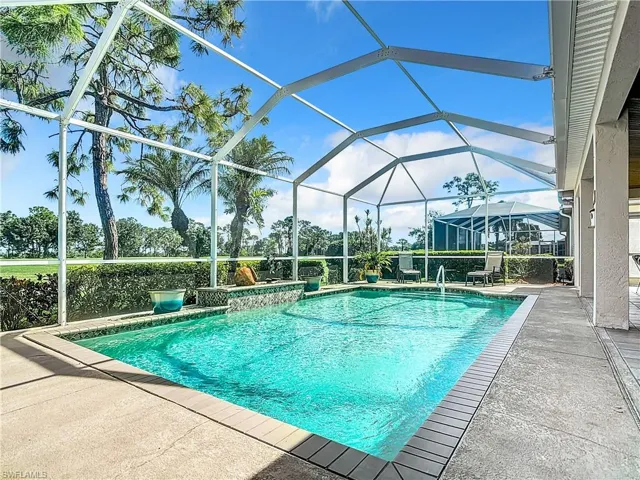 View of pool with a patio and a lanai