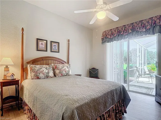 Bedroom with access to outside, ceiling fan, and hardwood / wood-style flooring