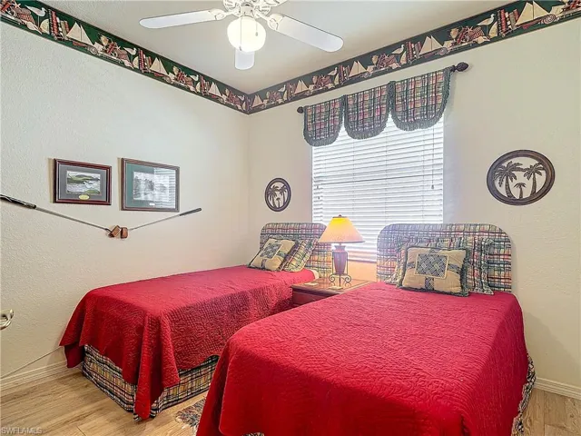 Bedroom featuring ceiling fan and hardwood / wood-style flooring