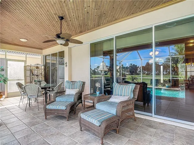 View of patio / terrace featuring ceiling fan and a lanai