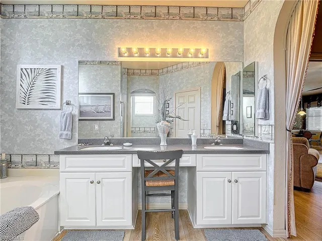 Bathroom featuring vanity, a washtub, and hardwood / wood-style floors