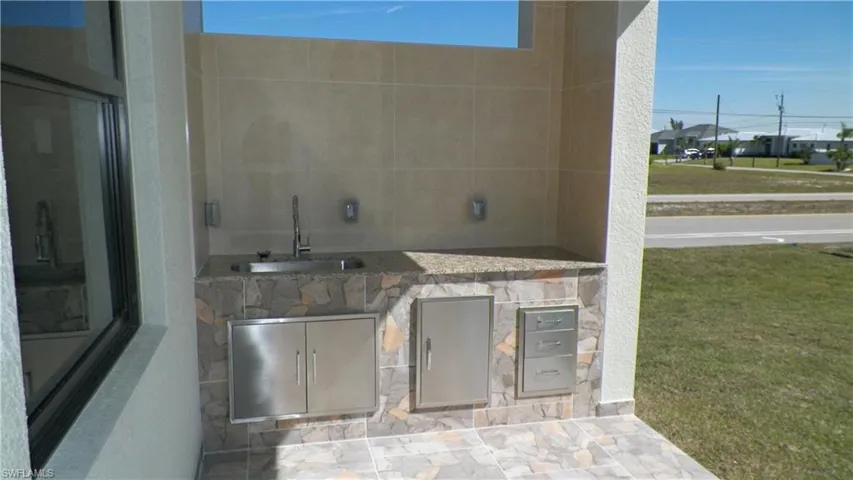 View of patio / terrace featuring a sink and exterior kitchen