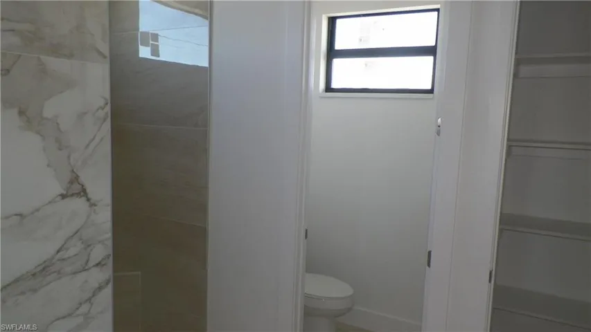Bathroom with toilet and walk in shower