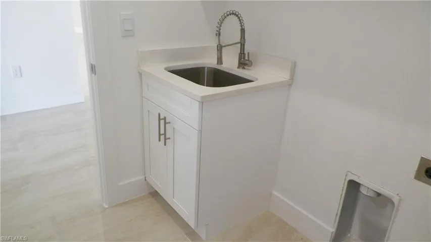 Laundry area featuring a sink and cabinet space