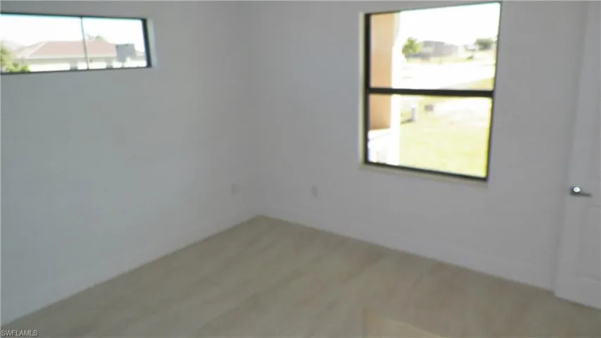 Spare room with wood finished floors and baseboards