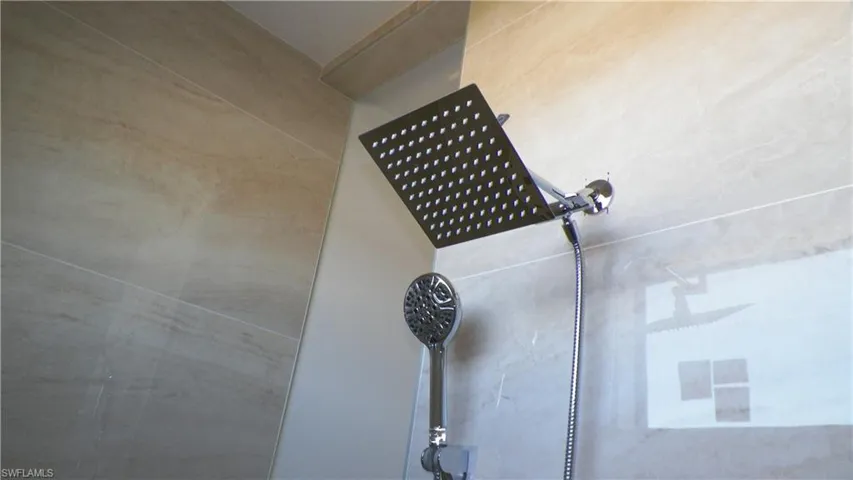 Interior details featuring a tile shower