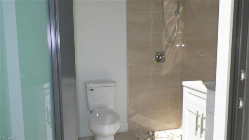 Full bathroom with a shower stall and toilet