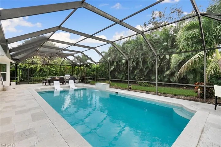 View of swimming pool featuring a patio and a lanai