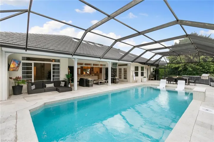 View of swimming pool with a patio area, a lanai, and outdoor lounge area