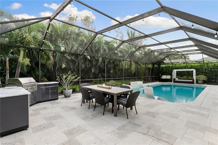 View of pool with a patio and a lanai