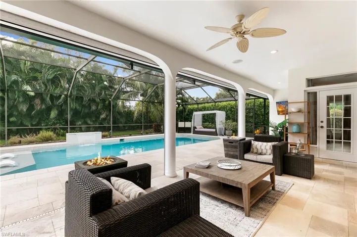 View of pool featuring a patio, ceiling fan, a lanai, and an outdoor hangout area