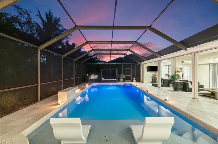 View of pool featuring an outdoor living space, a patio area, and a lanai
