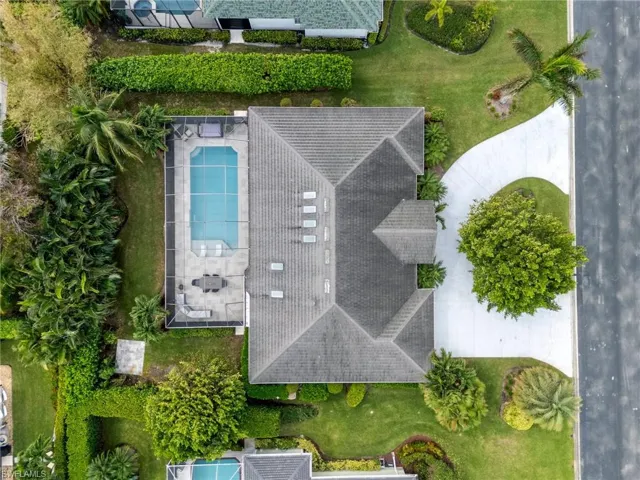 Additional paved pad outside in lush private yard on .31 acres