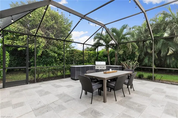 View of patio featuring a lanai and a grill
