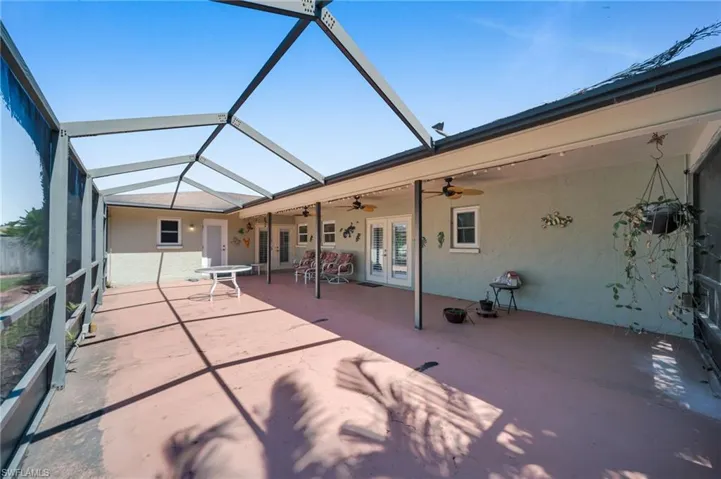 Unfurnished sunroom with french doors and a ceiling fan